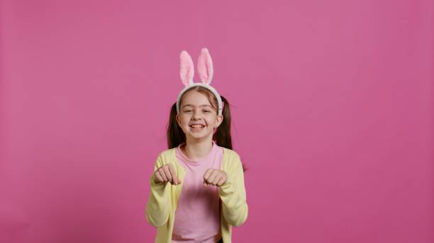istock Joyful carefree schoolgirl jumping around in studio 2060438696