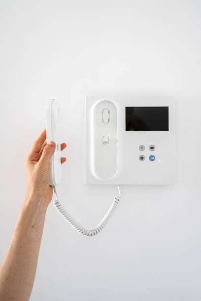 istock Woman answer call at intercom while guest rings the doorbell 2060446171
