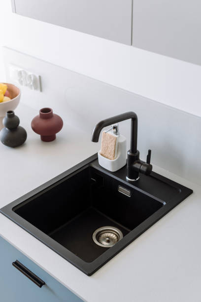 istock High angle view on stone sink and black faucet at kitchen with modern interior 2060446712