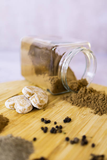 Dry ginger bread spice in a jar with sliced orange and cinnamon stick.