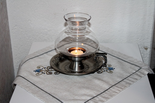 A nice tin candlestick with a glass cup