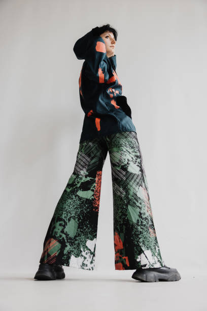 Cool Looking Woman Turns Slightly Backward, Revealing Her Back While Maintaining A Subtle Twist In Her Stance Fashion Portrait
