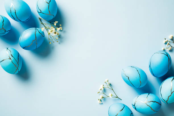 istock Easter egg with marble stone effect and spring flowers on pastel blue background. Top view. Flat lay. 2060464444