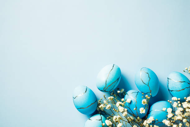 istock Painted Easter eggs and spring flowers on a blue background. Top view, flat lay. 2060473463