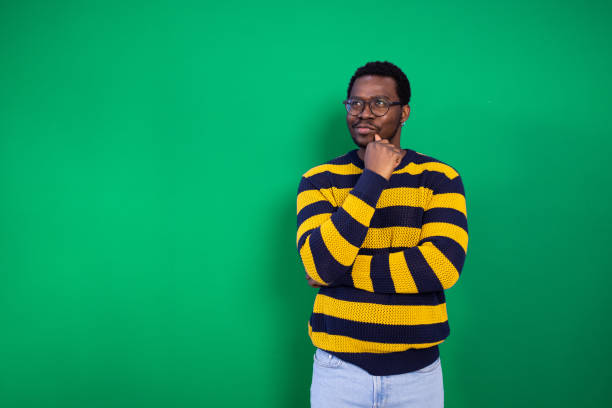 Studio portrait of a young, pensive African American man.