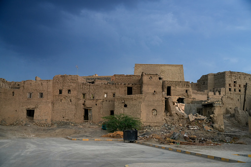 Evening over village ruins surrounding historic Bahla Fort in Nizwa, Oman.