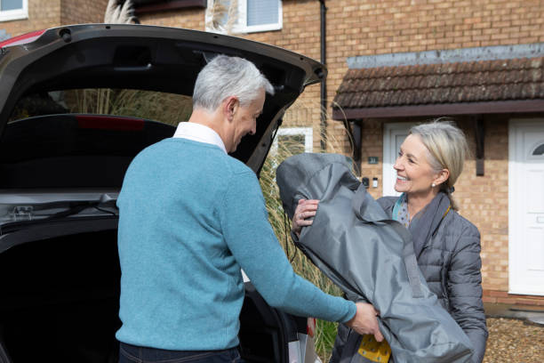 istock Mature couple loading a garden chair into a car boot 2060491108