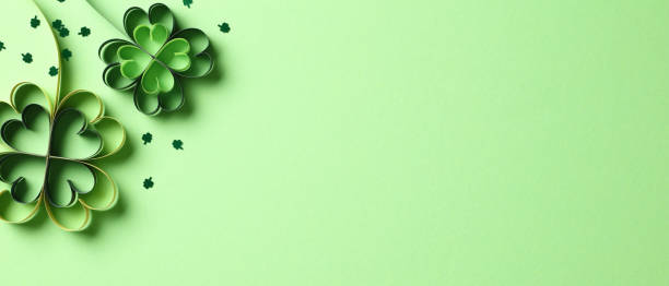 istock Four leaf clover paper cut with confetti on green background. St. Patricks day concept. 2060492287
