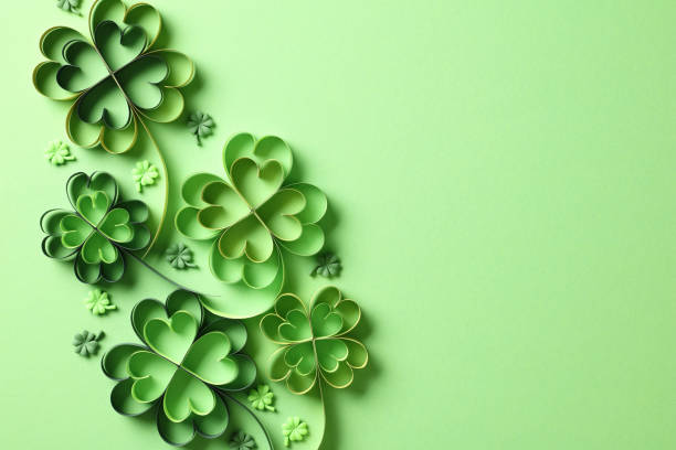 istock St Patricks day background with paper cut four leaf clover on green background. Flat lay, top view. 2060494946