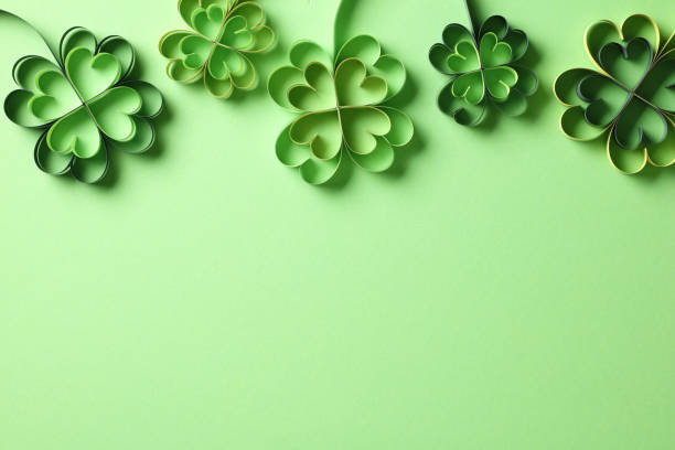 istock St Patricks Day banner design with four-leaf clover paper art. Flat lay, top view. Happy St. Patrick's Day concept 2060496066