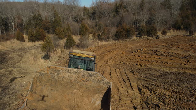 Heavy Duty Earth Moving Equipment Loader Building Livestock Pond in Midwest USA Missouri Aerial Video
