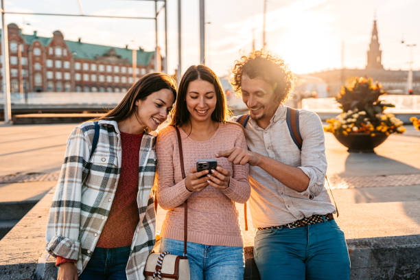 istock Three Young Friends Using Smart Phone In Copenhagen In Denmark 2060501861