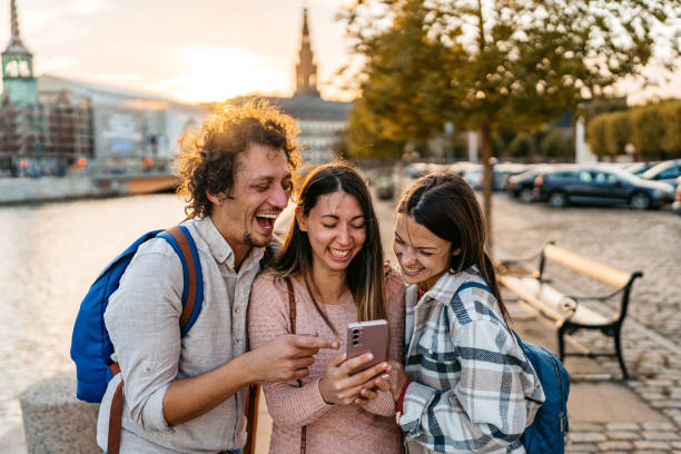 istock Three Young Friends Using Smart Phone In Copenhagen In Denmark 2060507332