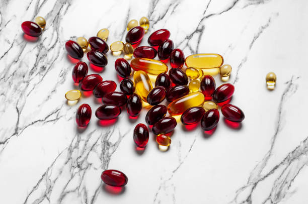 istock Pile of Red and Yellow Pills on Marble Surface 2060513763