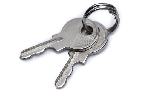 House Key With House Keychain Isolated on a White Background.