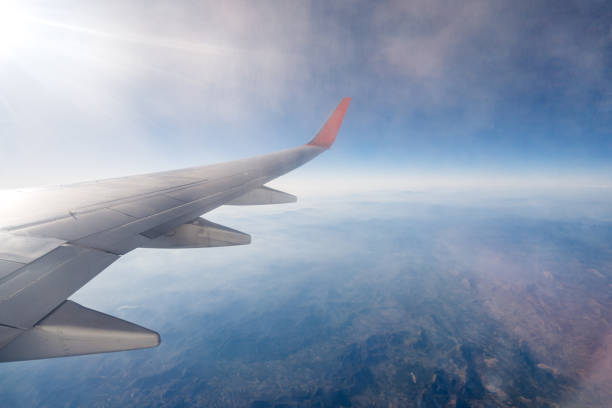 view from the airplane window mid-air - cloud mid air cloudscape aerial view imagens e fotografias de stock