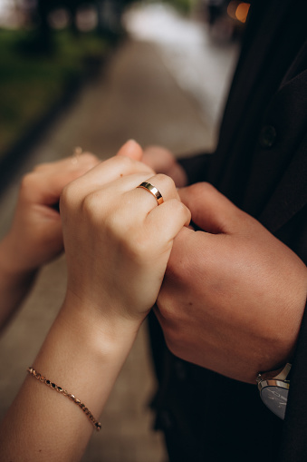 Bride and groom holding hands outdoors. High quality photo