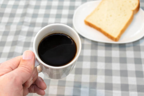Coffee cup and bread on the table in the morning