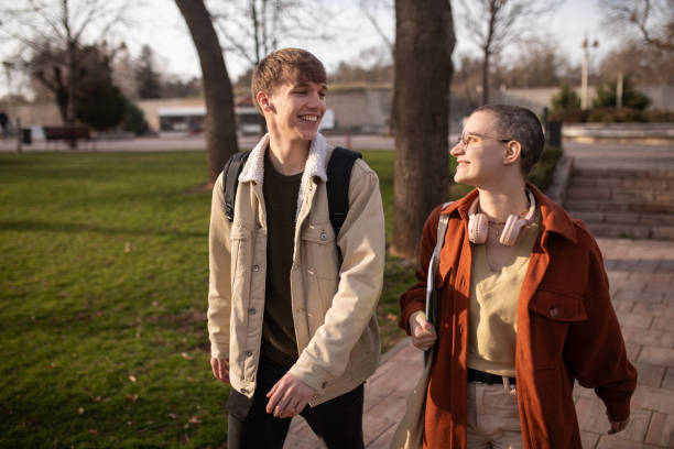 istock Young students walking together in a park 2060553771