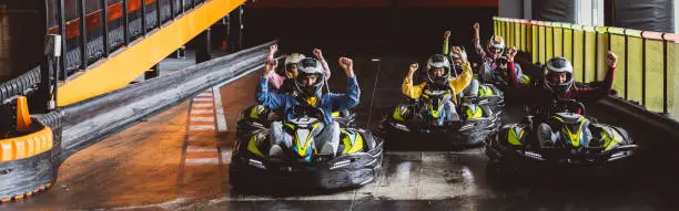 Photo of Go-Kart Racers group of young friends generation z celebrate winning race