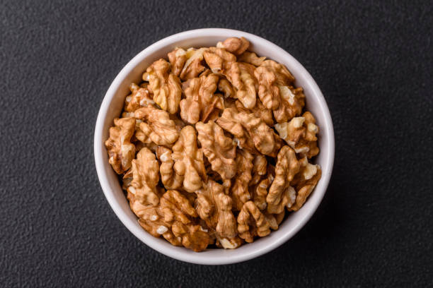 istock Delicious fresh peeled raw walnuts in a ceramic plate 2060585245