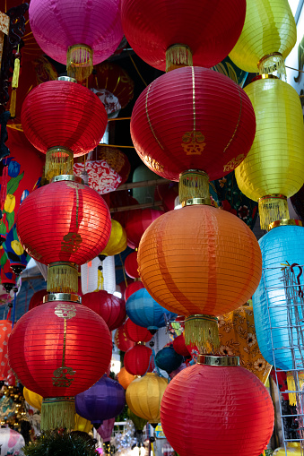 Traditional Vietnamese silk lantern light covers in various colors and styles sold at a street market in Hanoi.