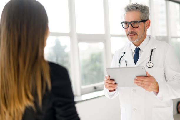 istock Experienced confident senior doctor with grey hair talks with a patient 2060618674
