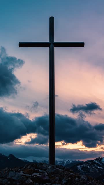 Vertical video of Clouds moving fast over religious cross in peaceful evening nature, christian symbol of religion and faith time lapse