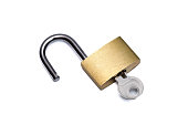 An unlocked gold padlock with a key lies isolated on a white background with space for text
