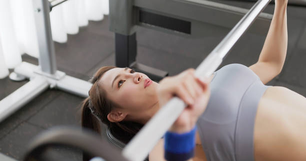 istock asian female gym bench press 2060651589
