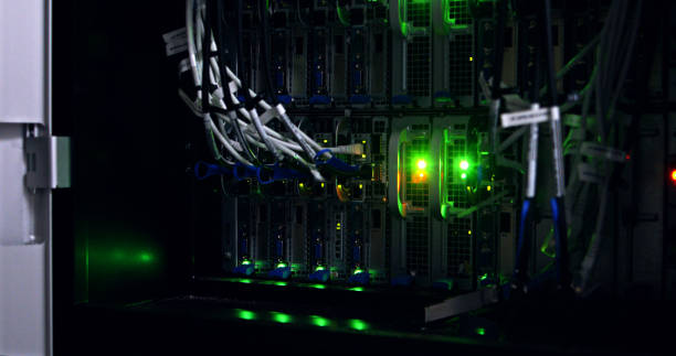 Cables, green light and server room for information technology, cybersecurity or GDPR at night. Connection and network with machine, engineering or data center in neon for hacking or online system