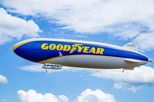 Palm Beach, Florida, USA - September 23, 2012: The Goodyear Blimp makes its way across the Atlantic shore against a beautiful sky. Shot was taken from the 20th floor of a building to capture the eye-level view of the Blimp. Operated by Goodyear Tire and Rubber Company, the Goodyear Blimp is  used for advertising purposes and for aerial views of sporting events.