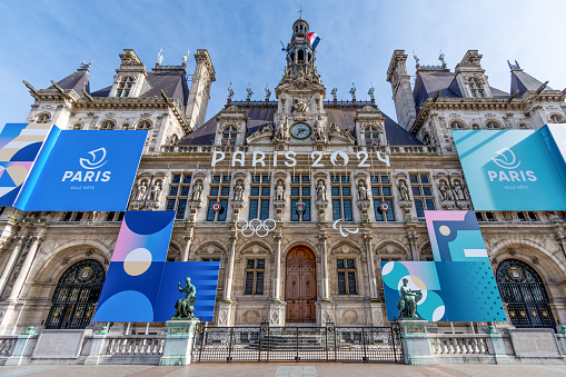 Paris, France - March 4, 2024: Facade of the town hall of Paris, France, decorated for the Olympic and Paralympic Games. Paris is the host city of the 2024 Summer Olympics