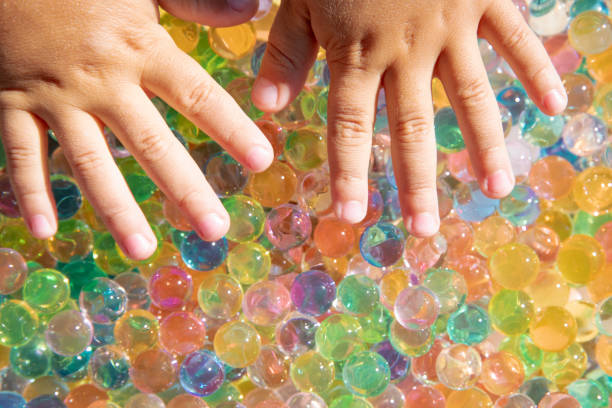 istock Colored balls of hydrogel touch children's hands. Sensory sensations. 2060681304