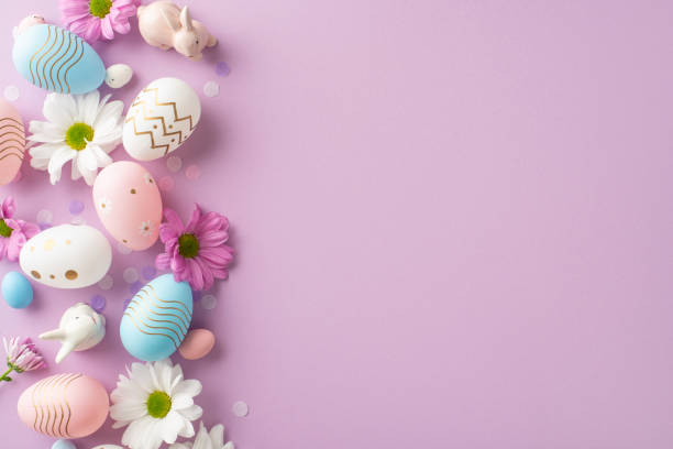 istock Elegant Easter scene from a top view, featuring eggs, ceramic hares, flowers, and confetti on a gentle lilac backdrop, with space for text or promotional content 2060685012