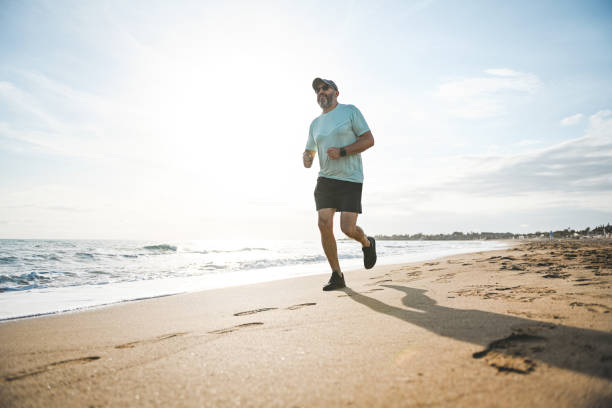 istock Man walking and doing sports on the beach 2060726366