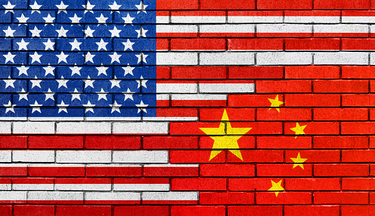 Flags of America and China is painted on clean brick wall