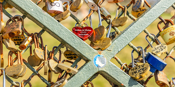 Paris, France - September 10, 2023 : Close-up on love locks attached to a fence on Montmartre hill in Paris France