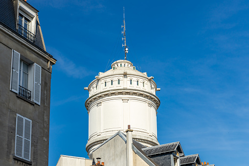 Paris, France - September 10, 2023 : Top of the Montmartre water tower with blue sky in Paris, France