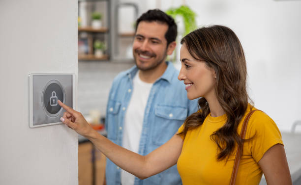 istock Couple leaving their smart home and locking the house using a security system 2060736795