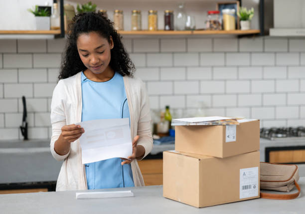 istock Nurse at home looking at a utility bill she got with her mail 2060737364