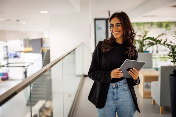 istock Beautiful woman with digital tablet looking away 2060746973