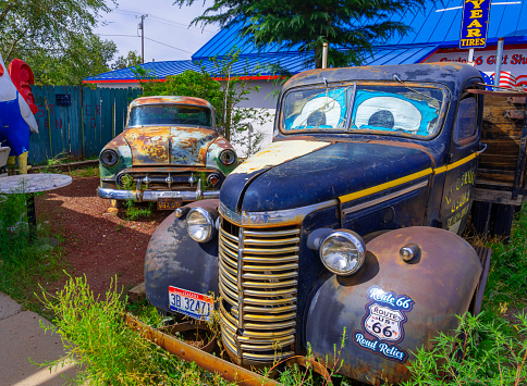 Seligman, Arizona, United States - September 22, 2023: Rusty Vintage Trucks Parked in a Garden of a Gift Shop