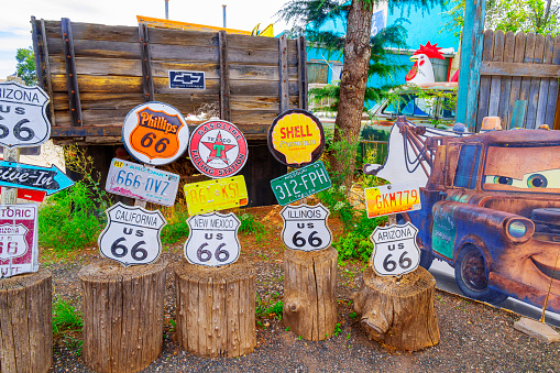 Seligman, Arizona, United States - September 22, 2023:  Board with Route 66 items, license plates, and signs