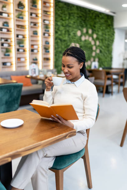istock Beautiful woman enjoin coffee and reading book 2060750363