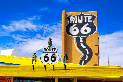 Seligman, Arizona, United States - September 22, 2023: Graphic statues of musical frogs on a roof of a gift shop