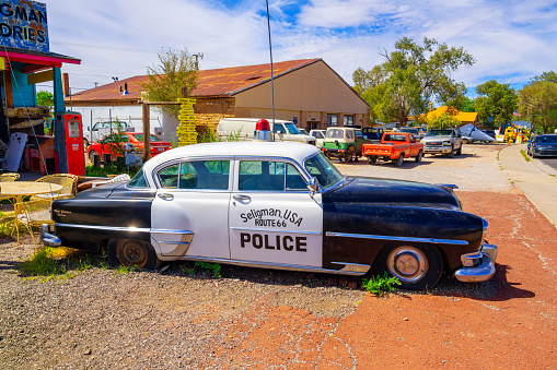 Seligman, Arizona, United States - September 22, 2023: Vintage Police Car in front of a gift shop