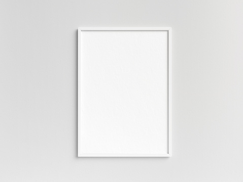 Empty white photo frame template hanging on the wall