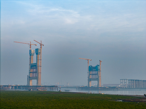 The tower crane of the under construction cross sea bridge is working