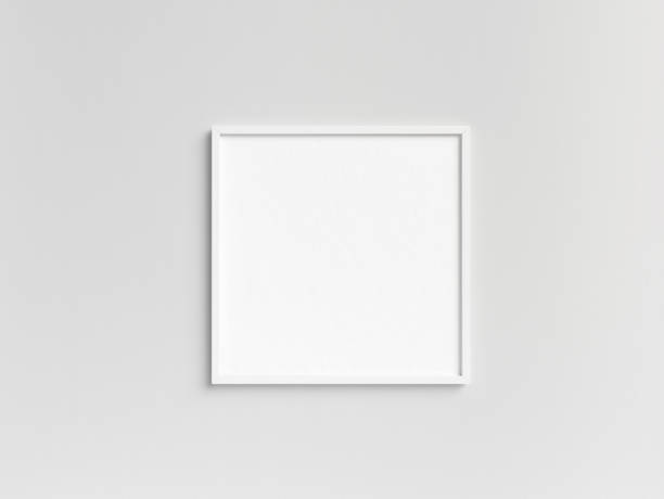Empty square white photo frame template hanging on the wall